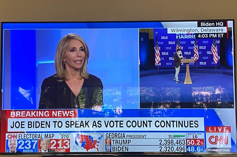 On the television screen, CNN anchors discuss the continuation of counting votes and possible outcomes. The 2020 Presidential Election commenced on Nov. 3 and continues today as ballots are still being counted in states such as Georgia, Michigan and Pennsylvania. 