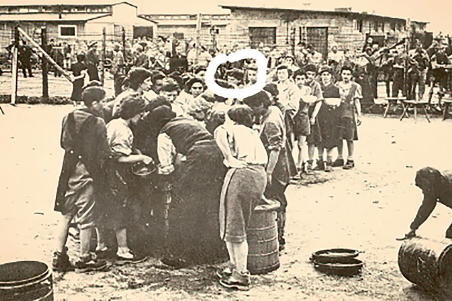 Liberation Day May 5, 1945: my great grandma (woman with white circle around her face) and other prisoners were given new boots and clothes after being freed from Mauthausen by the Americans. My great-grandma later moved to the United States, settling in Brooklyn, New York. 