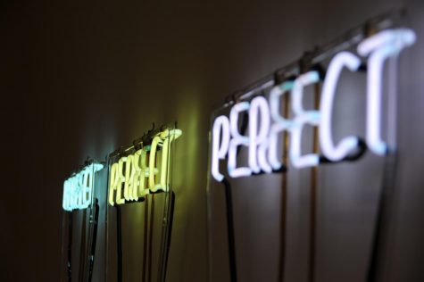 Three neon signs illuminate the word Perfect in colors turquoise, yellow and white in the Museum of Modern Art in New York. My love-hate relationship with perfectionism has taken on a new meaning as I continue to evolve and grow older. 