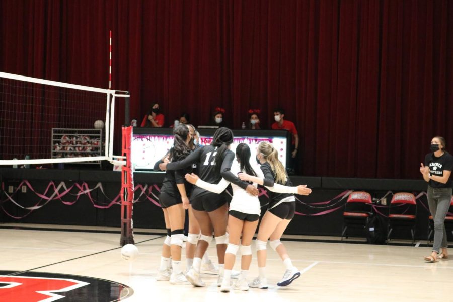 The varsity volleyball team comes together in a huddle at their recent match against Buckley. “Were all really great players individually, Milton said. [Were] just using our strengths as a team to keep persevering.
