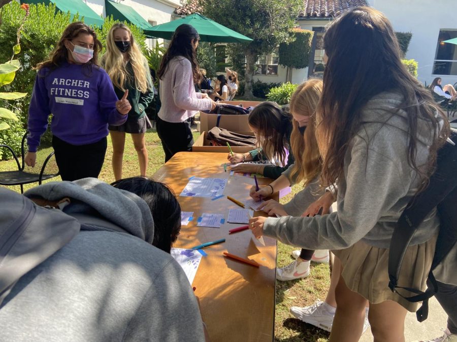 Students from various grades write notes and letters to Haitian girls about their favorite ways to express themselves. In the courtyard during the bake sale, Freshman August Kohn was passing out all of the brownies, cookies and cake pop truffles. The GEG members stations such as the mural, empower grams and the self affirmation mirror.