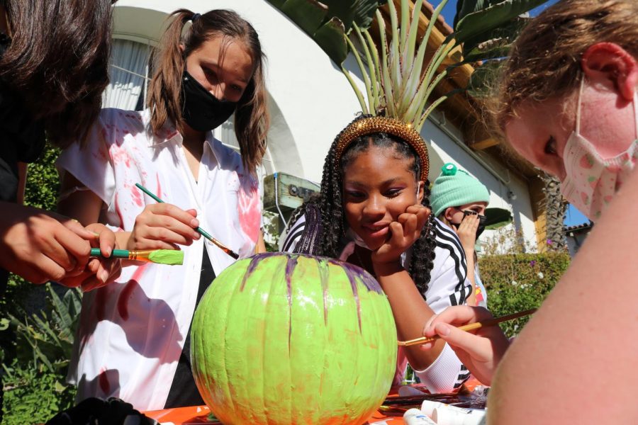 Eighth-graders Julia Ong, Shayla Covington and Callie Roth represent their grade in the pumpkin decorating contest. Teams from all grade levels had to use their own supplies to transform the pumpkin in 15 minutes.