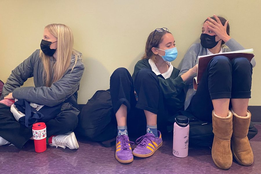 uniors Letizia Oetker, Azel Al-Kadiri and Margaret Morris sit in a hallway before class studying for an upcoming biology test.