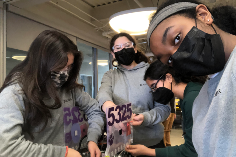 Alejandra Cortes (24), Lily Dembo (24), Shayaan Gandhi (25) and Chloe Hayden (24), all members of Archer’s robotics team, The Muses, work on their robot at their first competition. The meet was held on Sunday, Nov. 21 at the YULA Boys High School.