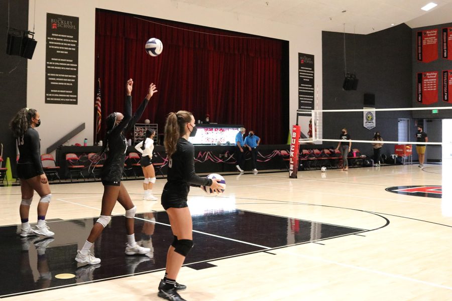The varsity volleyball team warms up at a match against Buckley in mid-October. A big focus of mine for this season was connection, Fenster said. Just getting to know a lot of the girls outside of volleyball.