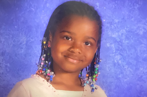 A photo of me when I was in the first grade. This is before I began to get box braids and still wore traditional cornrows with beads. This was a hairstyle I wore for the majority of my childhood.
