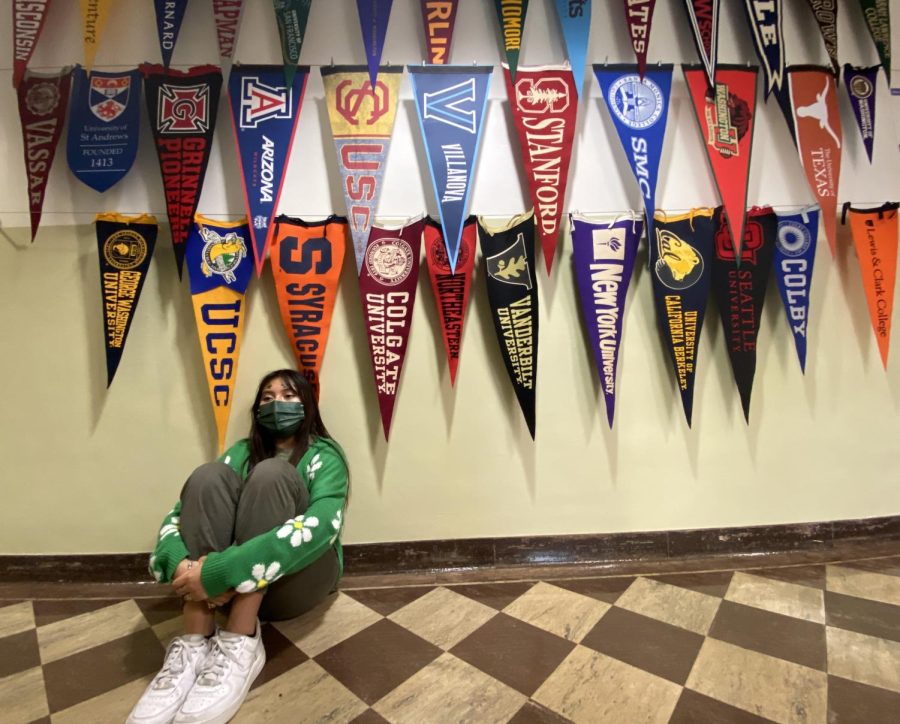 I+sit+under+the+various+alumni+pennants+that+are+hanging+in%C2%A0the+business+hallway.+When+I+sat+below+the+pennants%2C+I+felt+nothing+but+admiration+for+the+previous+alumnis+accomplishments.+I+hope+I+can+be+like+them+in+my+own+way.