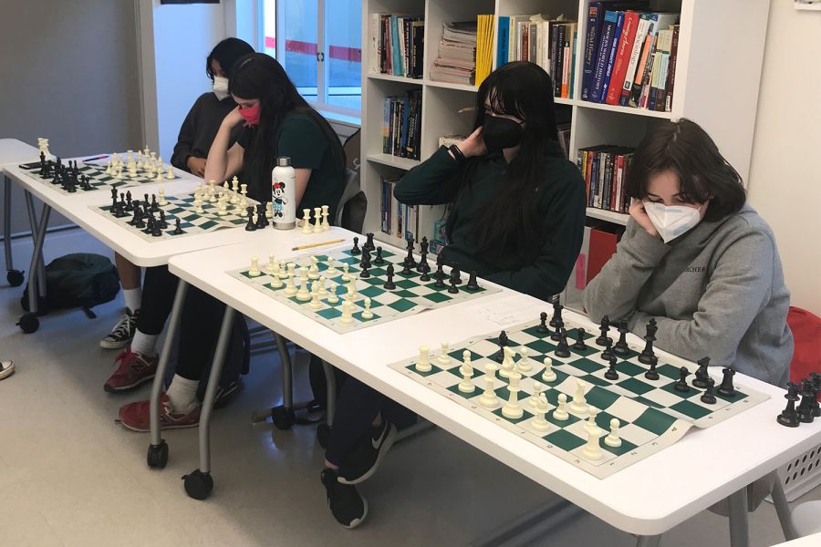 Four+members+of+the+Chess+Club+think+pensively+about+their+next+moves+during+a+round+of+chess.+Chess+Club%2C+Callighraphy+Club%2C+Stitch+Perfect+and+Mental+Health+Club+are+all+clubs+on+campus+full+of+creativity%2C+impact+and+community.