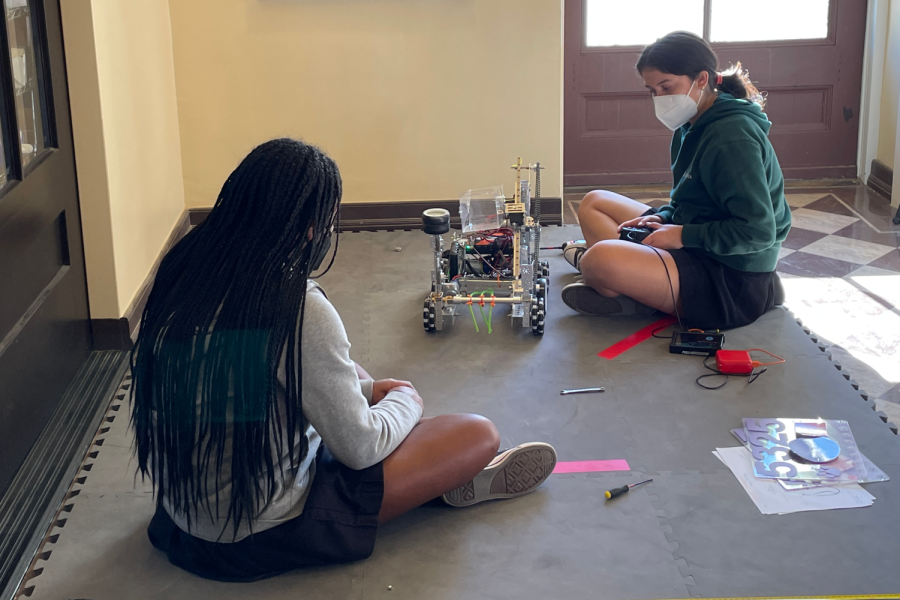 Alejandra Cortes (24) and Chloe Hayden (24) work on their robot, practice running it and make any necessary adjustments before using it in competition. On Feb. 20, The Muses competed in a qualifying tournament at Monrovia High School.