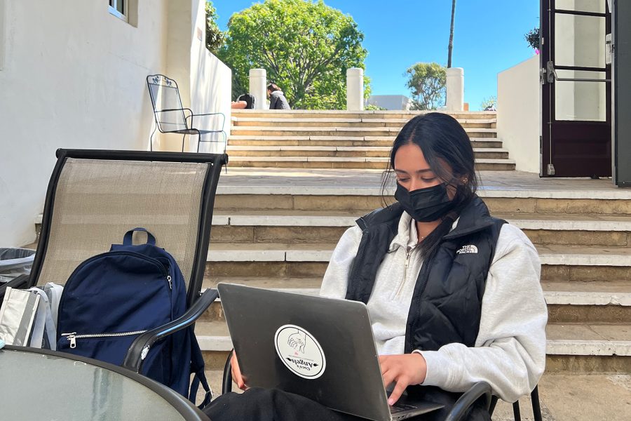 Junior Maya Bajaj works in the library courtyard with her mask on. Archer removed its outdoor mask mandate Feb. 16 for vaccinated students and employees. Its just an instinct to wear a mask, Bajaj said. I dont really notice it anymore.