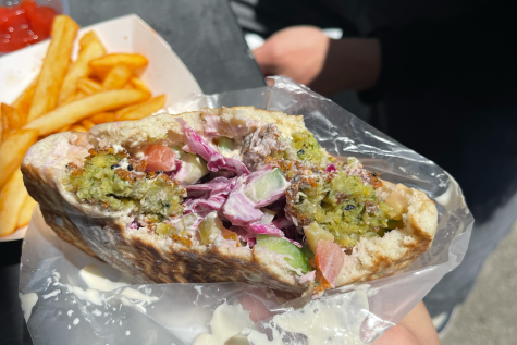 The falafel pita, served with perfectly fried falafel, red cabbage, tomatoes, pickles, cucumbers, tahini, and hummus. A deliciously classic falafel pita.