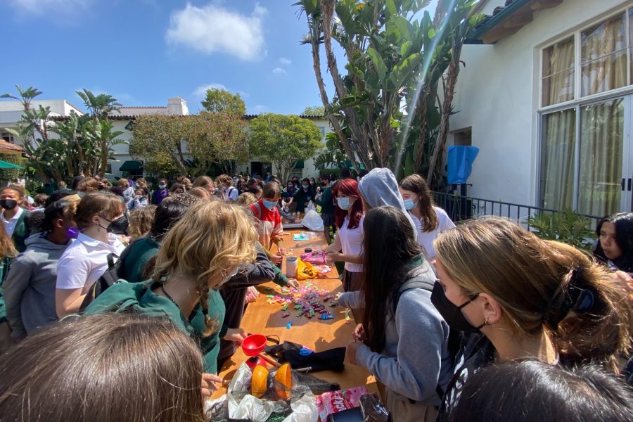 Students gather around tables in the courtyard to celebrate Asian American and Pacific Islander Heritage Month. Whether they were eating Asian snacks or playing games, everyone pitched in to celebrate.