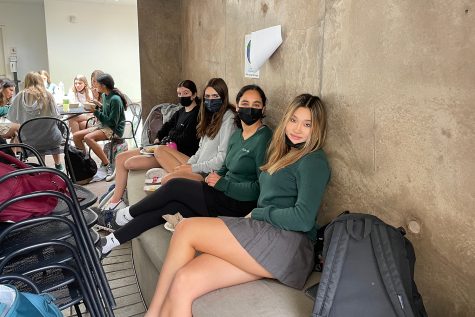 Sophomores Bella Teitelbaum, Emi Marmol, Nina Arjomand and Ella Chang sit under the steps of the amphitheater. Sophomore Lilly Dembo said that she likes sitting on the floor of this area most lunches.