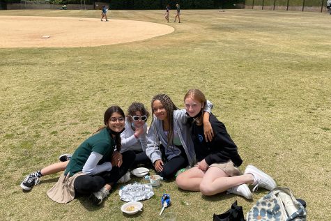 Sixth graders Mia Akkaraju, Caroline Youssef, Casey Young and Tessa Matzkin go to the back field to eat lunch together. They said they usually go there for lunch because they like having a lot of open space and being in the sun.