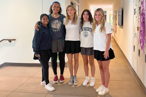 Nyah Fernandez (22), Vaughan Anoai (22), Thea Leimone (22), Chloe Fidler (22) and Gracie Doyle (22) embrace each other during their celebration in one of their final classes. The former editors reflected on their time writing for The Oracle and the life lessons they learned along the way. 