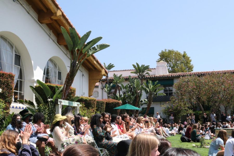 The Class of 2022, dressed in floral patterns, sits in the courtyard while they listen to tributes from students to other seniors at the Senior Tea Party, Tuesday, May 24. Its a bittersweet moment to be here for our last week, but I love being around my grade, senior Sophia Farmer said. 