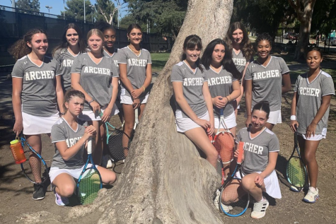The junior varsity tennis team pose for a picture after a victory against Marymount where they won 16-2. This season, the team has played two matches so far and hold a record of 1-1. 