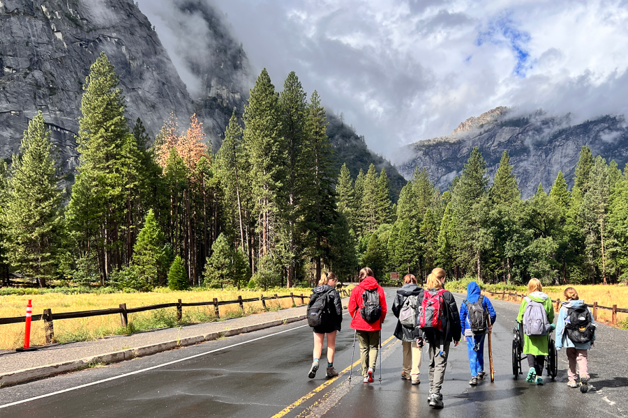 Eighth grade students walk along a road at the start of their day. During Arrow Week, students had the opportunity to see Columbia Rock, El Capitan, Yosemite Falls and Yosemites spider caves.