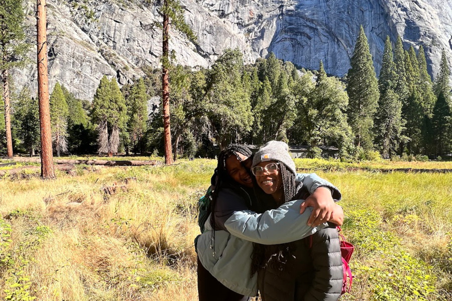 Eighth graders Milan Earl and Beau Cartwright smile and hug in front of a mountain in Yosemite. According to Sustainability, Environmental and Outdoor Education Specialist Casey Huff, she worked with other Archer faculty to change the trip from seventh to eighth grade and to have it be in Yosemite so that younger students could have their first Arrow Week in California.