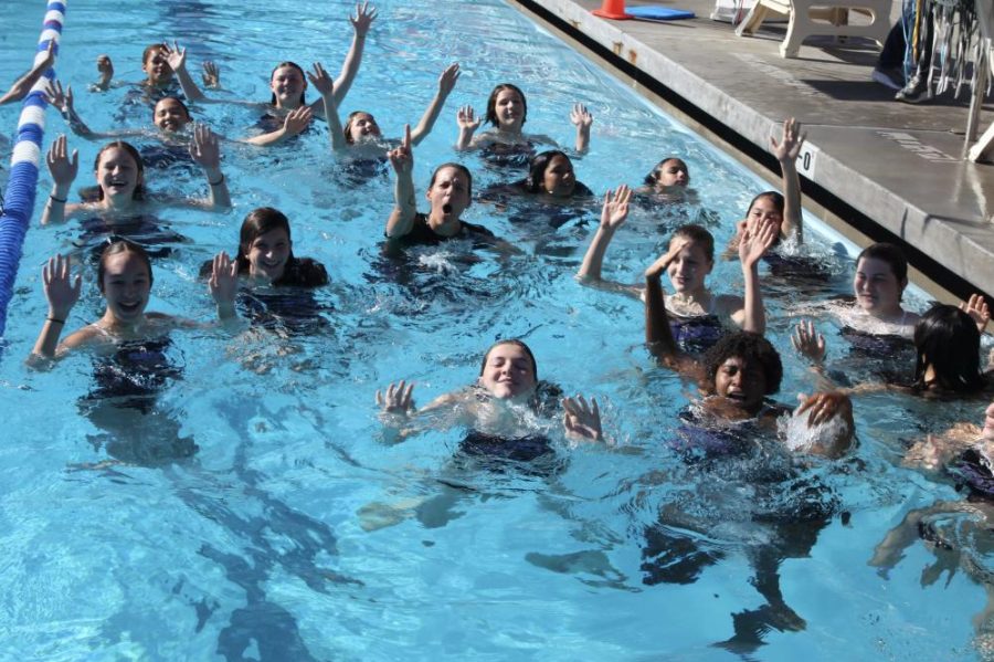 Swimmers on the middle school swim team throw their hands up in celebration after winning the PBL championship. The PBL final took place at Palisades Charter High School Nov. 5.