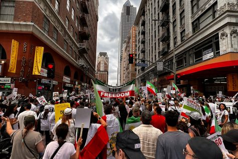 Protestors march down a street in Downtown, Los Angeles near Pershing Square. The protest, responding to the death of Mahsa Amini in Iran,  took place mid October, and senior Delara Tehranchi took part in the  demonstration with her family.   