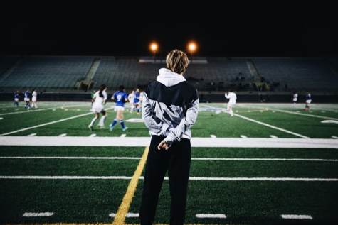Director of Athletics Kim Smith watches her team compete in a game at night. After coaching Archer soccer for 11 seasons, Smith has decided to step down this year.