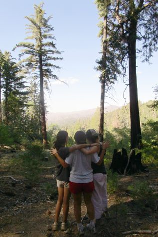 During their fall outing, Margaret Morris ('23), Rose Chuck ('23) and Azel Al-Kadiri ('23) hugged as they looked out at the green mountains.