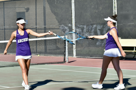 Seniors Sydney Frank and Rose Sarner congratulate each other after a match against Buckley Oct. 18. After a successful season, the varsity tennis team advances to the CIF Division II playoffs, as well as individual playoffs.
