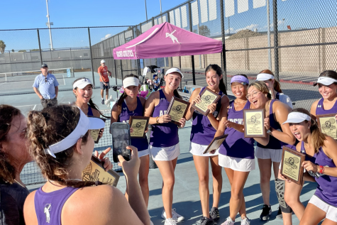 Archer's Varsity tennis team poses with placards after a first-time win at the annual First Serve Tournament Sept. 24. The First Serve Tournament is an annual sporting event. (Photo Credit: Andrea Frank)