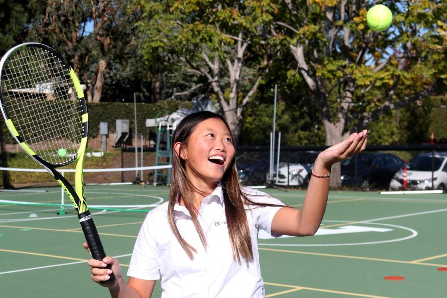 Sophomore+Carrie+Xue+tosses+a+tennis+ball%C2%A0while+she+holds+a+tennis+racket.+2022+was+Xue%E2%80%99s+first+year+at+Archer+and+she+joined+Archer%E2%80%99s+tennis+team.+%E2%80%9Csomething+very+fun+to+be+a+part+of.%E2%80%9D
