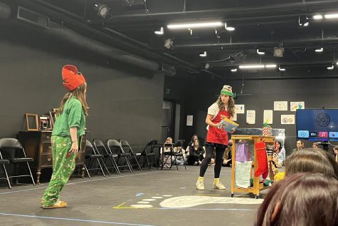 Sophomores Bryce Collis and Hayden Seid perform a scene from holiday movie “Elf” during a Drama Queens performance. Students, faculty and family members watched holiday-themed scenes prepared by students in the advanced theatre class in Archer’s Blackbox Dec. 15.