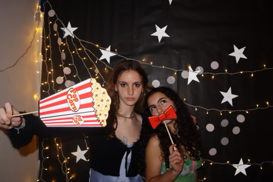 Olivia Boehm (’26) and Sara Salehi (’26) pose at the photo booth at the ninth and 10th grade social. The social also included a ping pong table and music Friday, Feb. 3. Photo by Caroline Collis, used with permission.