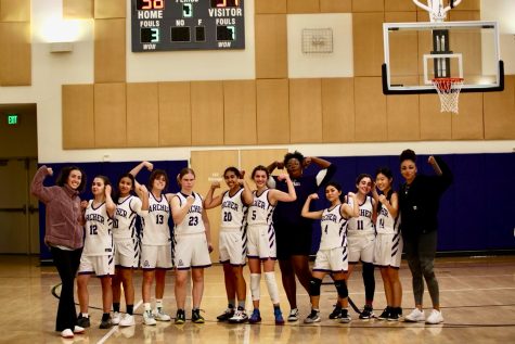 The varsity basketball team poses together after winning a game against Le Lycée Français de Los Angeles. The game took place on Dec. 14, and the score was 35-31.