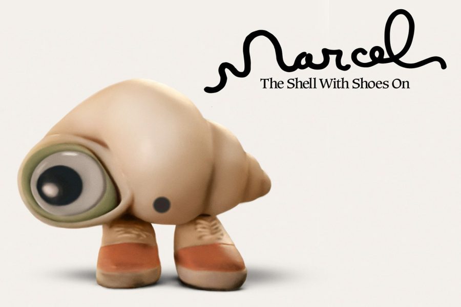 Marcel%2C+the+one-inch-tall%2C+one+eyed+shell+stands+with+his+pink+shoes+on.+The+curious%2C+resourceful+and+heartwarming+shell+has+been+entertaining+viewers+in+short+films+for+almost+13+years%2C+but+he+finally+made+his+big+screen+debut+in+2022.+Image+Source%3A+A24+promotional+poster.