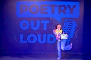 Asomugha poses in front of a Poetry Out Loud wall after winning the LA competition. The event was held Sat., Feb. 4, at Lineage Performing Arts Center, Pasadena.