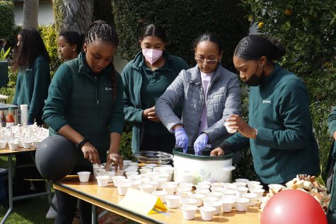 Freshmen Sydney Curry, Simonne McDavid, Eden Sinclair and junior Laila Charles serve Himbasha, an Ethiopian celebration bread, during Archers Taste of Soul food festival. Griffin said food was an informal, unique activity to effectively immerse students into Black culture.