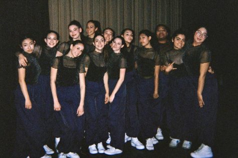 Junior and senior dancers in Advanced Study Dance stand backstage at The Broad Stage in black and mesh sparkly tops, baggy pants and sneakers before their dance, "The Great Gatsby," the opening performance in Night of Dance. 