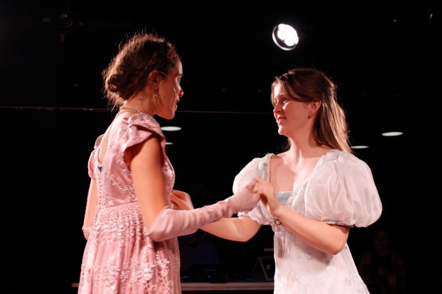 Azel Al-Kadiri (23), portraying Elinor Dashwood, and Ella Gray (24), portraying Marianne Dashwood, hold hands during a technical rehearsal of Sense and Sensibility. Rehearsals for the upper school play began in January and spanned over three months.