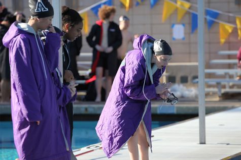Senior Lily Prokop cheers on her teammate at the first swim meet of the season. As club and non-club athletes on the swim team do not practice together, meets are a unique time to build connections within Archers swim community.