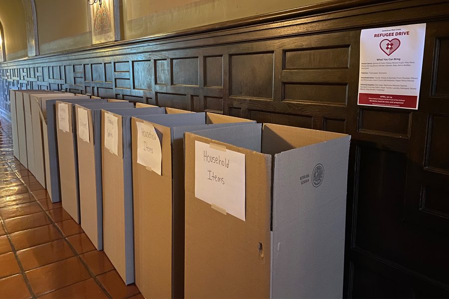A row of cardboard boxes lines the front hallway wall where students can donate items. Between Monday, April 10, and Monday, April 17, students donated to the American Red Cross Drive for refugees fleeing unsafe conditions.