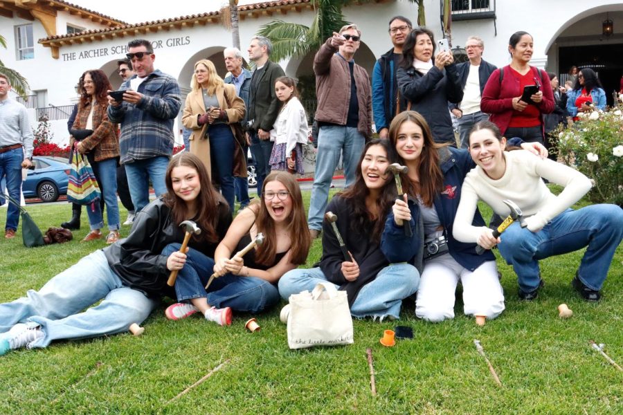 Seniors hold their hammers in preparation for the Maypole setup Sunday, April 30. The Maypole setup is an annual tradition held each spring. Seniors tie their ribbons to stakes, which they then hammer into the ground to create rows of taut ribbon. 