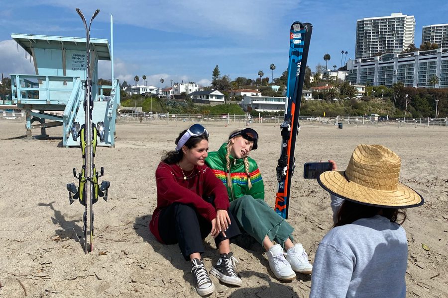 Senior Sydney Frank films seniors Margaret Morris and Letizia Oetker in ski gear at the beach for a lip-syncing video. The students in the French Senior Seminar class went to the beach March 8 to film their submission for the inaugural ARCHERVISION competition.