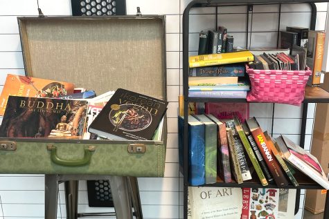 This is a photograph of Katsu Bar's mini library. The library is a way for the restaurant to connect with their customers and create a fun way for the community to give back or simply pick up a book during their meal.