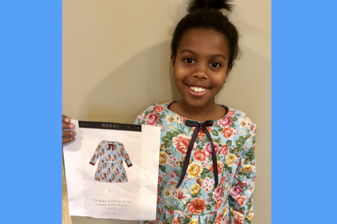 An 8-year-old me holds up a photo of a Gucci dress, wearing the duplicate I made myself. Months earlier, I became infatuated with it in the mall, which inspired me to start sewing. I still make clothes to this day.