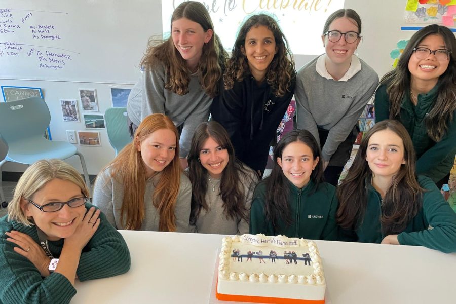The yearbook staff and Head of Scholastic Journalism Kristin Taylor gather around a cake in celebration of completing the 2022-2023 edition of the Hestia’s Flame. There have been 27 volumes of the yearbook, each tasked with reporting the most important, newsworthy moments of the school year.