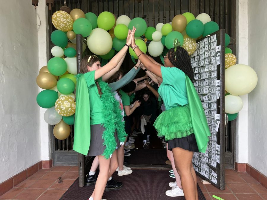 Student Body President Anaiya Asomugha (24) and Executive Board member Tess Hubbard (24) hold their hands up to create a human tunnel as the younger students run through. Moving Up Day took place June 2 and commemorated non-graduating students and their achievements this year.