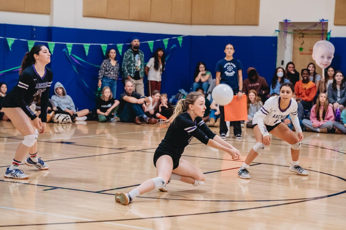 Senior Gemma Larbalestier dives for the ball during the game against Milken Community School. The varsity volleyball senior night ceremony took place after the game.