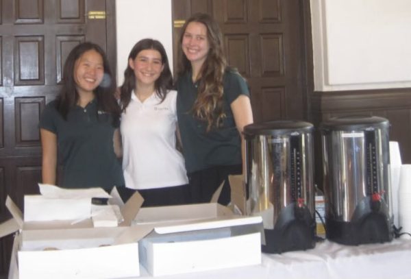 Class of 2025 Student Council representatives Rachel Chung, Francie Wallack and Tavi Memoli smile in front of boxes of donuts and containers of hot water to mix with hot chocolate packets. Chung served as photographer for the event, documenting the party on her digital camera. The juniors’ autumn party was meant to provide a space to talk to their peers and relax in the midst of their academics. 