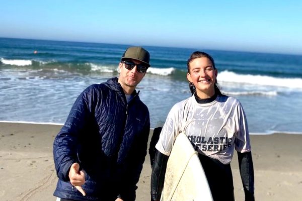 Senior Chloe Resnick and world language teacher Mark Forte stand together at Zuma beach after Resnick competed in a surf competition. For the fall season, the surf team has expanded to include experienced middle school surfers. 