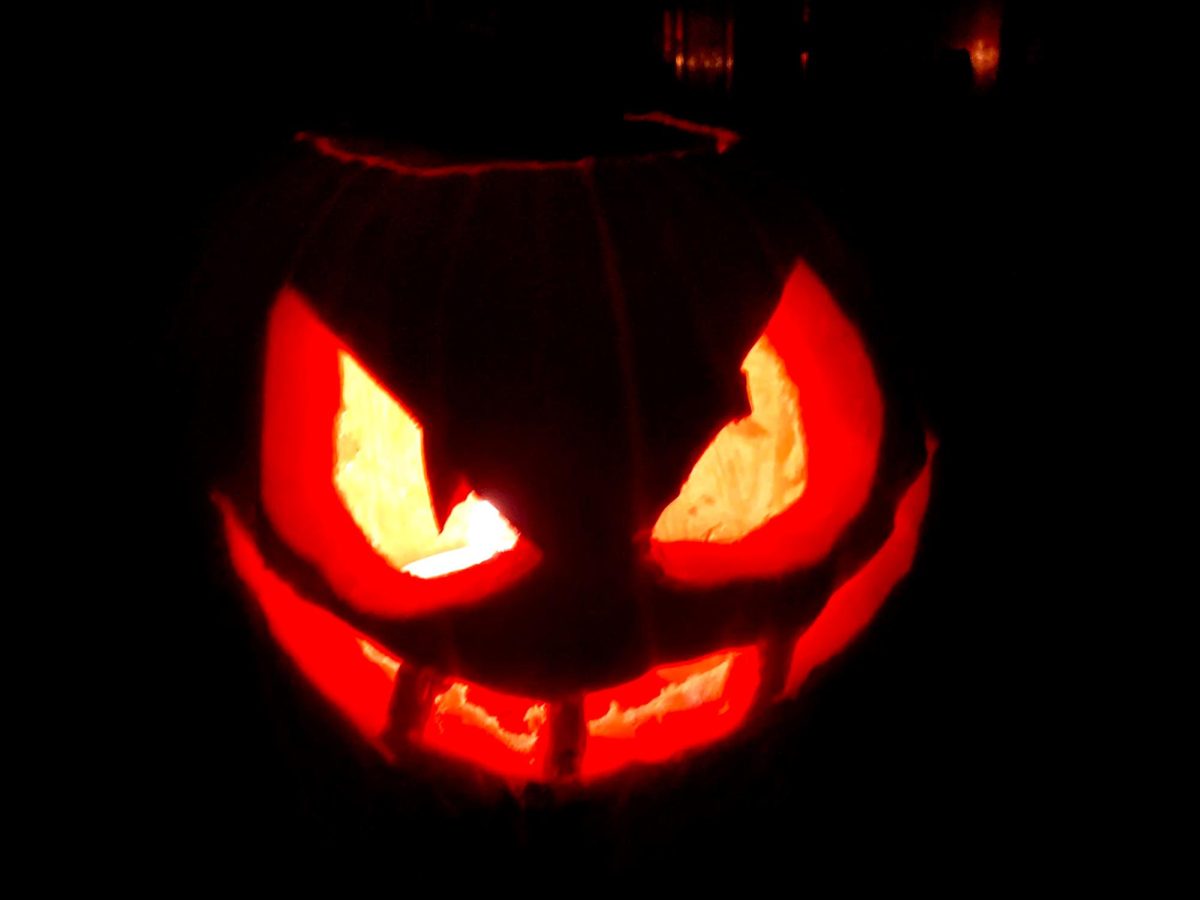 My jack-o’-lantern is lit up in the dark. Jack-o’-lantern faces can be silly, scary or even sad. Along with carving pumpkins, baking fun treats, watching scary movies and picking apples are some of my favorite activities to in the fall. 